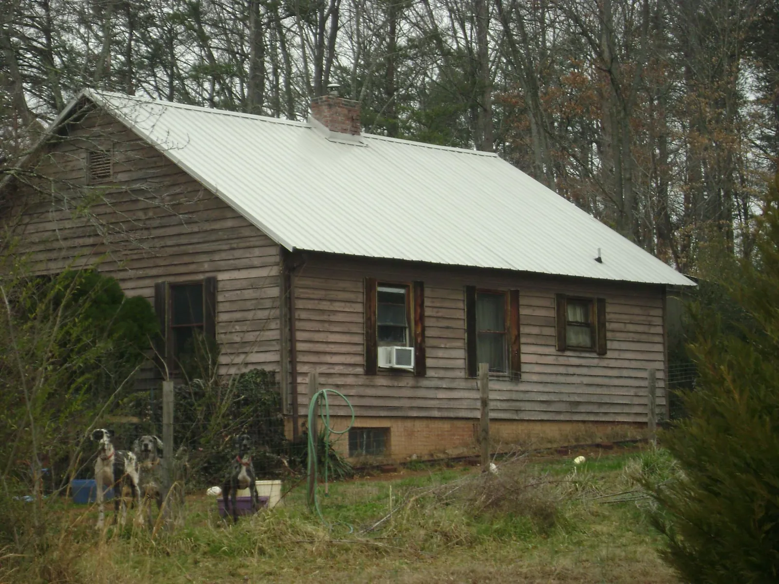 White metal roof on an old wood sided farmhouse, from a Metal Roof Installation job in Kanaranzi